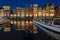 Amsterdam houses along the Damrak in Netherlands at night