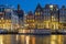 Amsterdam houses and house boats along the Amstel in Amsterdam Netherlands at sunset