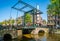 Amsterdam, May 7 2018 - the Aluminium bridge letting people cross the Kloveniersburgwal channel