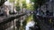 Amsterdam morning in center city - street with bicycles and cars on canal, Autumn, Netherlands