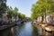 Amsterdam, Netherlands - 06/14/2019: canal with bridge and boats in Amsterdam, Netherlands. Traditional dutch cityscape.