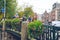 Amsterdam, Netherlands - 15.10.2019: Bicycles on a bridge over the canals of Amsterdam. Colorful houses and flowers. Autumn