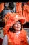 Amsterdam, Netherlands - April 27, 2019: Middle-aged woman dressed in classy orange costume celebrating the Kings day, Koningsdag