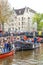 Amsterdam, Netherlands - April 27, 2019: People on party boats celebrating the Kings day, Koningsdag, the birthday of the Dutch