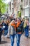 Amsterdam, Netherlands - April 27, 2019: People on the street wearing orange accessories celebrating the Kings day, Koningsdag,