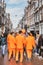 Amsterdam, Netherlands - April 27, 2019: Young people dressed in national orange color while celebrating the Kings day, Koningsdag