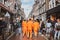 Amsterdam, Netherlands - April 27, 2019: Young people dressed in national orange color while celebrating the Kings day, Koningsdag