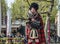 Amsterdam , Netherlands - April 31, 2017 : Scottish bagpiper tuning his instrument in the streets of Amsterdam wearing