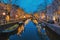 Amsterdam Netherlands canals with christmas lights during December, canal historical centre of Amsterdam at night