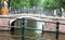 Amsterdam, The Netherlands, city canals, boats, bridges and streets. Unique beautiful and wild European city.