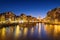 Amsterdam, Netherlands. Evening cityscape. Dark sky and city lights. Dutch canals.