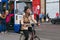 AMSTERDAM, NETHERLANDS - JUNE 25, 2017: Unknown woman riding on the bicycle on one of the central streets of Amsterdam.