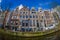 AMSTERDAM, NETHERLANDS, MARCH, 10 2018: Beautiful outdoor view Amsterdam canals with bridge and typical dutch houses