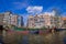 AMSTERDAM, NETHERLANDS, MARCH, 10 2018: Exterior shot of houseboats and apartment buildings on a canal in the city of