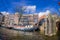 AMSTERDAM, NETHERLANDS, MARCH, 10 2018: Exterior shot of houseboats and apartment buildings on a canal in the city of