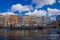 AMSTERDAM, NETHERLANDS, MARCH, 10 2018: Exterior shot of houseboats and apartment buildings on a canal in the city of