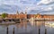 Amsterdam, Netherlands. Panoramic view of Central Train Station, Canal with ferry boats in the foreground.