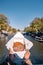 Amsterdam Netherlands, woman hand with Stroopwafel in Amsterdam - typical Dutch food - two circular pieces of waffle