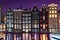 Amsterdam at night, Netherlands dancing houses reflected in Amstel river, old european city