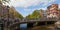 Amsterdam - Panoramic view of Amstel river with bridge and houses