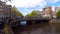 Amsterdam, Panoramic view of Bridge over Amstel river with people and bicycles