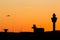 Amsterdam Schiphol airport control tower with an orange sunset