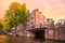 Amsterdam Sunset cityscape with canal, bridge and architecture