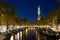 Amsterdam Westerkerk church tower at canal in the city of Amsterdam, Netherlands.