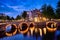 Amterdam canal, bridge and medieval houses in the evening