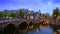 Amterdam canal, bridge and medieval houses in the evening