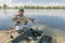 Amur fishing. Fisherman with grass carp fish in hands at lake