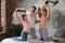 Amused family enjoying pillow fight at home