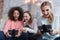 Amused girls holding game consoles and playing games