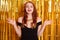 Amused happy gorgeous red haired female in cute black dress, spread hands welcoming sideways and smiling amazed, greeting friend,