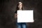 Amused Pre-Teen Girl With Freckles Holding Blank Sign