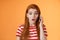 Amused thrilled redhead girl found out incredible news, talking phone, hold smartphone ear, stare camera surprised