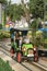 Amusement park. Young mother and two children ride in small car. Nanny rides with children in the park