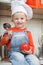 Amusing kid in a cook cap