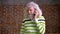 Amusing senior caucasian man with white hair and heavy beard, hanging on his phone and talking with smiley face