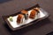 Anago sushi with wasabi on ceramic dish, boiled eel with sushi r