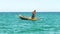 Anakao, Madagascar - May 03, 2019: View from small fishing ship sailing near shore, boat with unknown Malagasy fisher man near, he