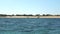 Anakao, Madagascar - May 03, 2019: View from small fishing ship sailing near shore, boats and Malagasy fishermen near beach,