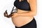 Analog camera resting on pregnancy bump