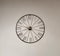 Analog clock with roman number on gray wall