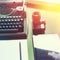 Analog Typewriter, Digital Tablet And Film Camera On The Green Table, Top View with Sunshine. Journalism Writing Concept