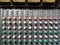 Analogue mixing console channels showing eq section and phantom power buttons line mic