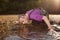 Analyst in chest waders bootfoot collecting samples of water