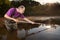 Analyst in chest waders bootfoot collecting samples of water