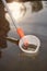 Analyst in chest waders bootfoot collecting samples of water