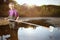 Analyst in chest waders bootfoot collecting samples of water